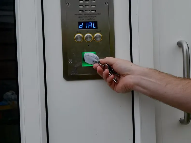 Key fob held to the reader on a door entry panel